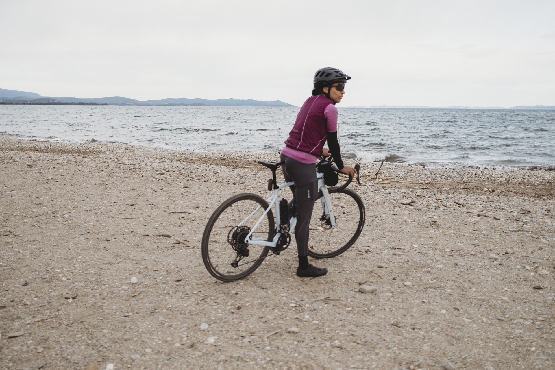 Frau auf Gravelbike am Meer